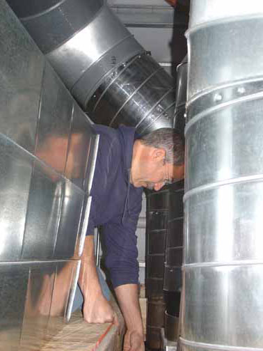 Joe Wilson, working near the ductwork he's already mounted in the Freedom Barn